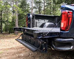 Power-folding tailgate in truck bed